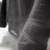 Close up of hanging charcoal towel in bathroom.