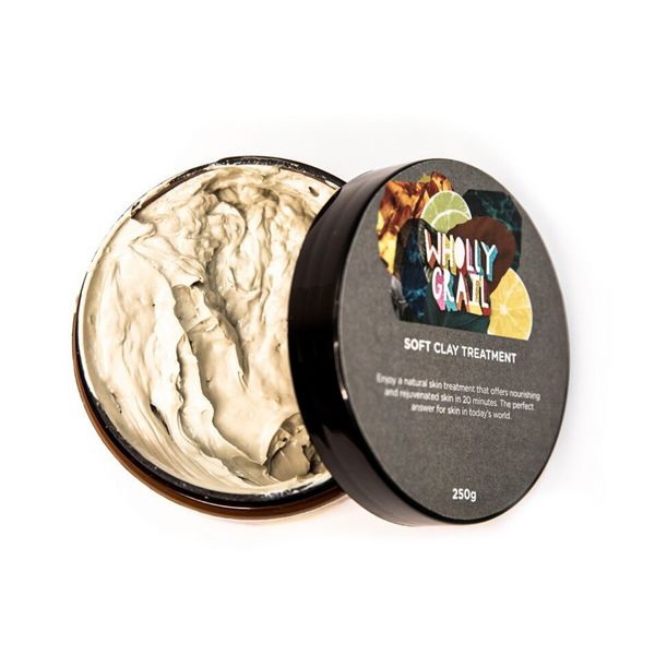 Top view of soft clay treatment in open tub showing textured product with lid aside the jar, on white background