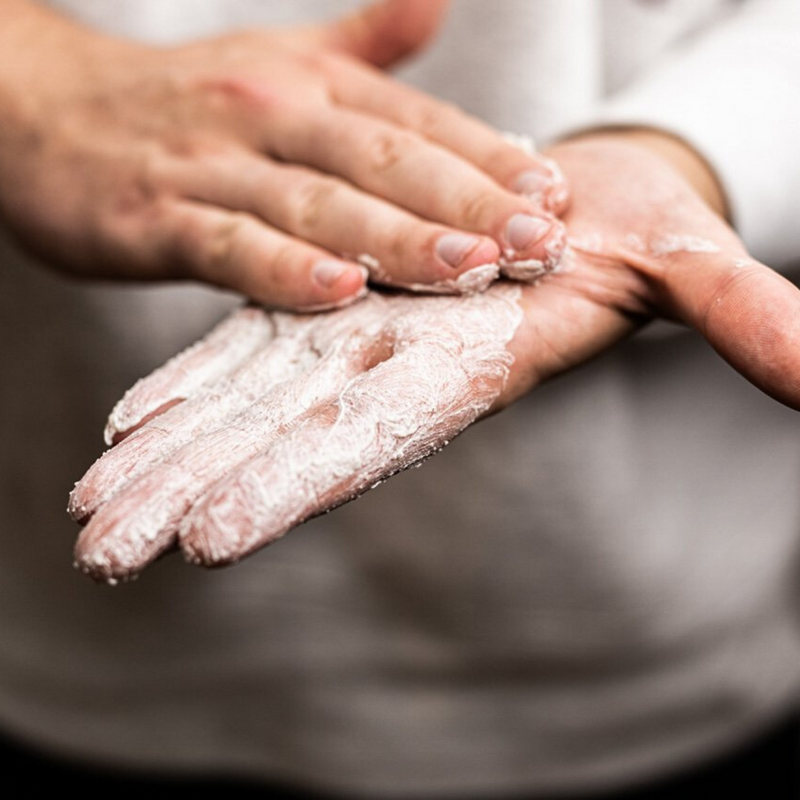 Close up of man scrubbing hands with Whollygrail skin scrub