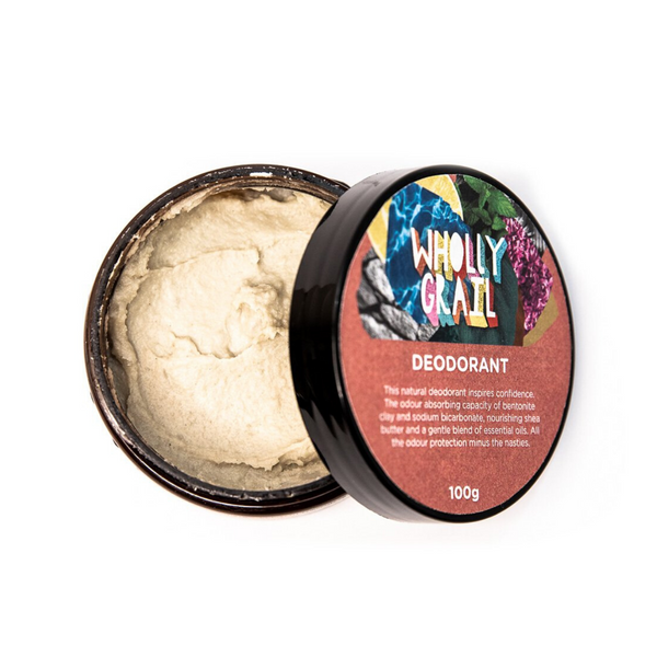 Image from top down of natural deodorant tub open with lid aside to reveal texture of deodorant, on a white background