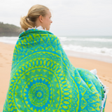 Organic mandala towel wrapped around girl at the beach.